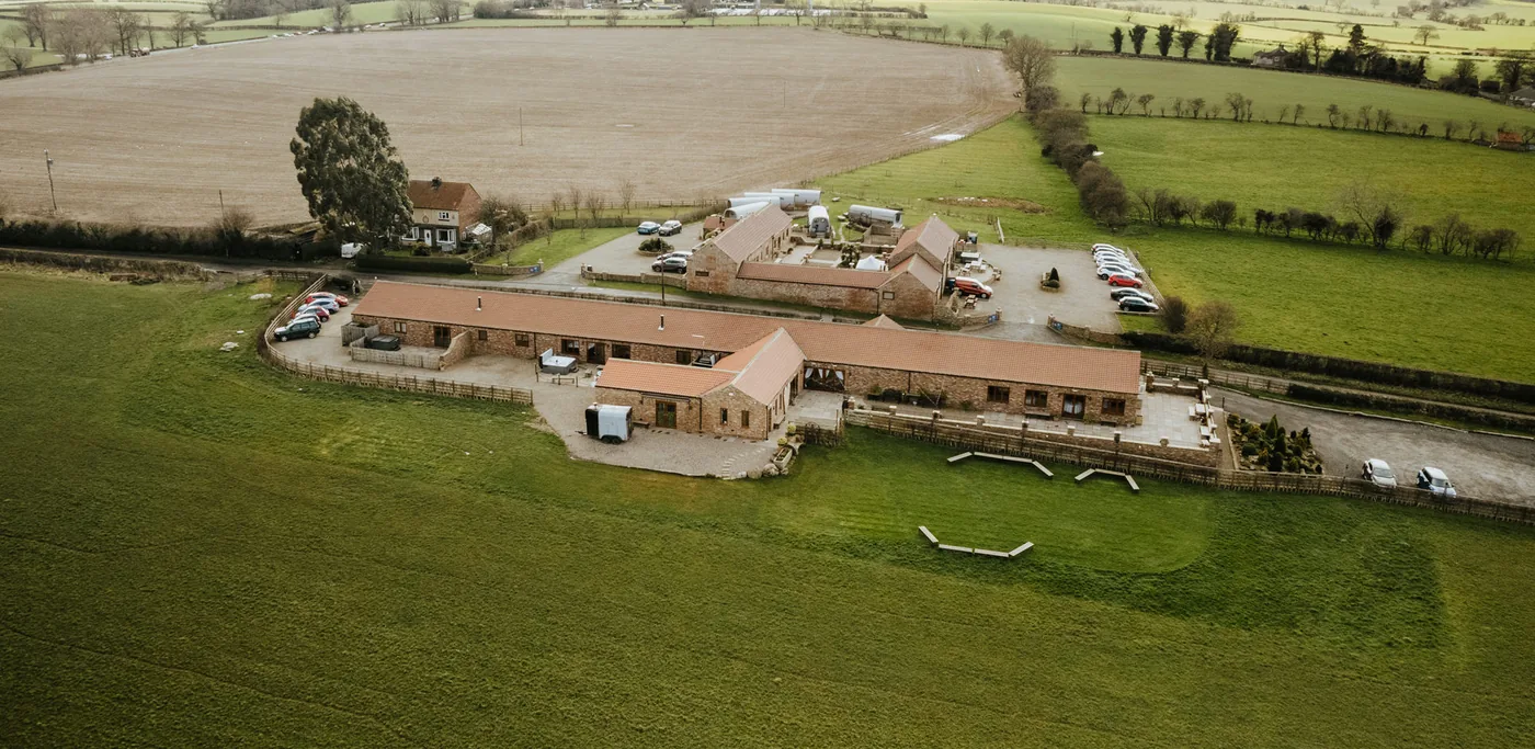 Thief Hall's brick barn ranges, courtyard and accommodation across the estate