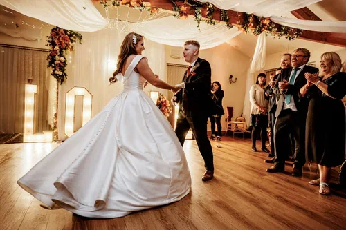 The bride's skirt swirling as the couple dance together.