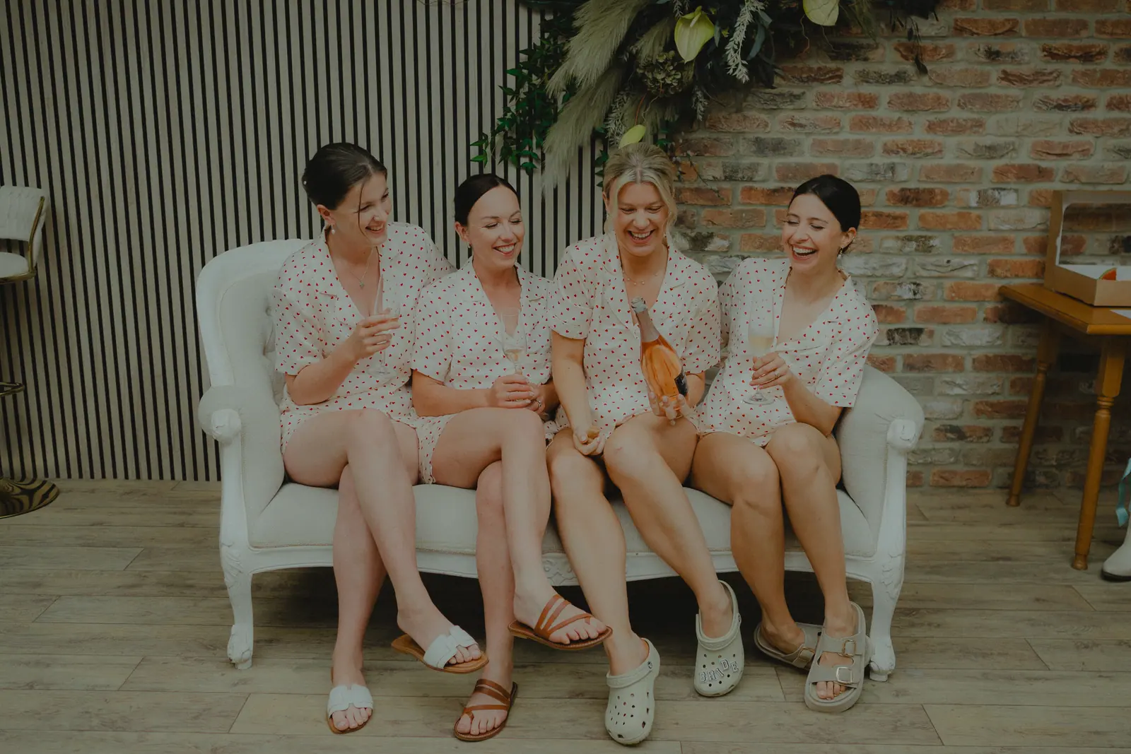 Alice getting ready with three women in matching red-heart outfits