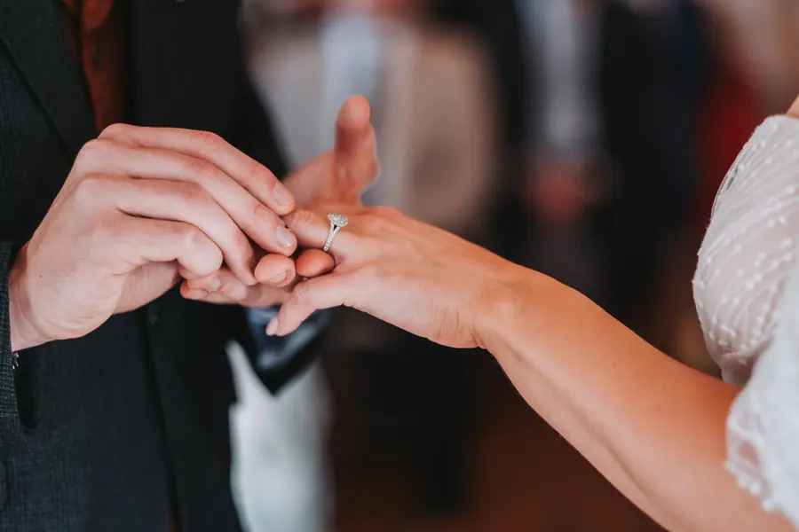 A ring being placed onto Evie-Mae's hand during the ceremony