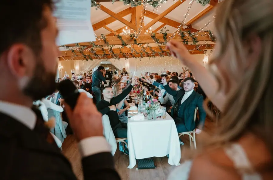 Guests applauding across the Hall as the couple enter dinner