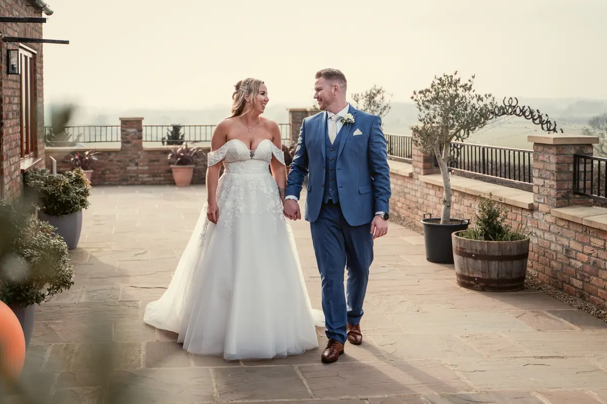 Hayley and Jayrrd walking together across the Thief Hall terrace