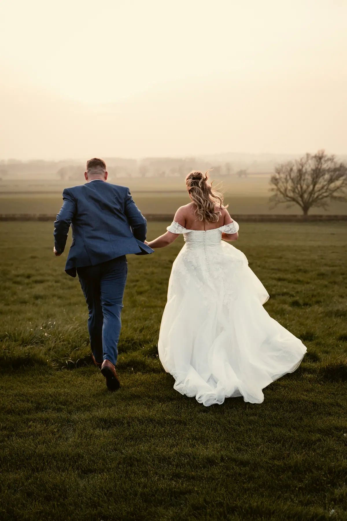Hayley and Jayrrd walking away together across the open fields