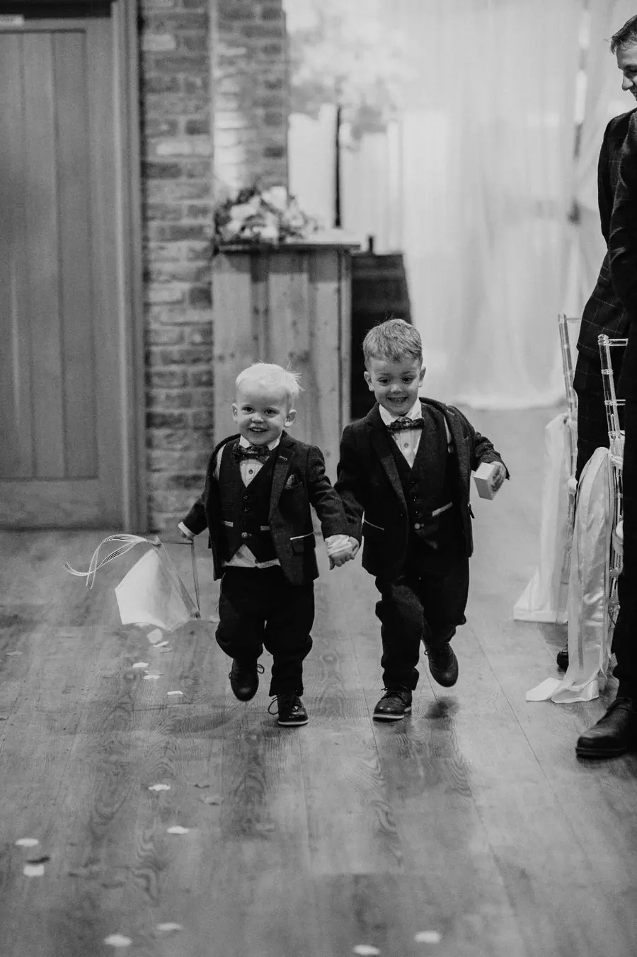 Two young boys walking together across the polished Hall floor