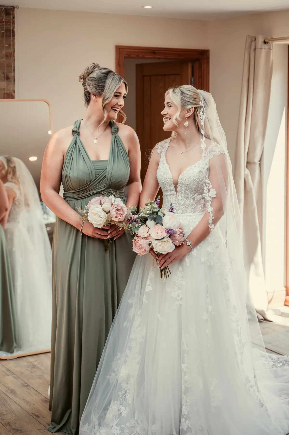 Katie speaking with three women in pale green dresses indoors