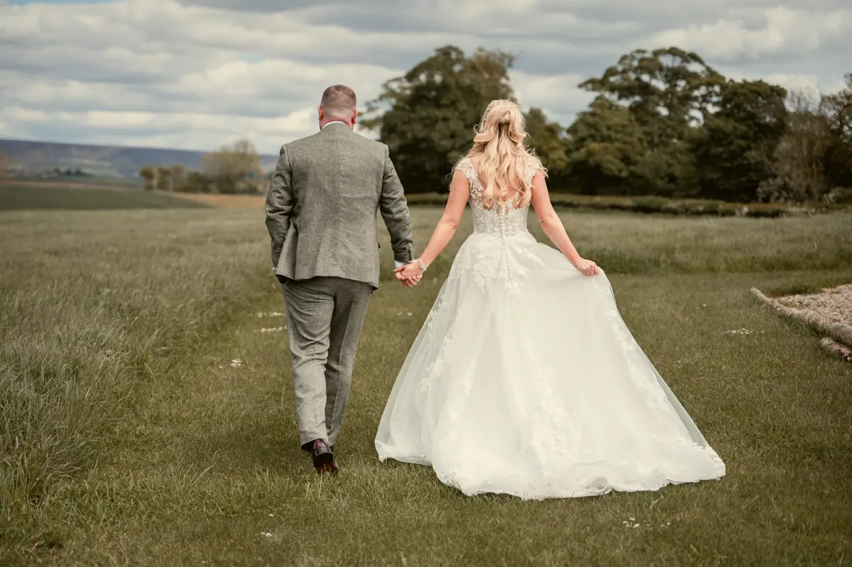 Katie and Chris walking away together across the open grassland