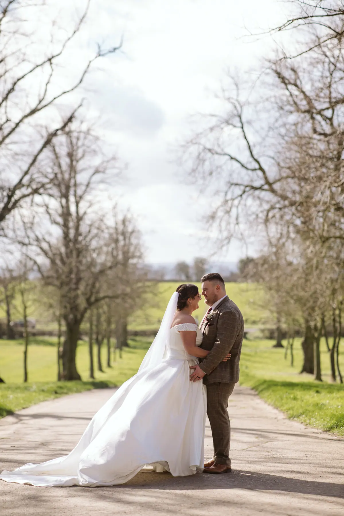 The couple standing together on the tree-lined Thief Hall lane