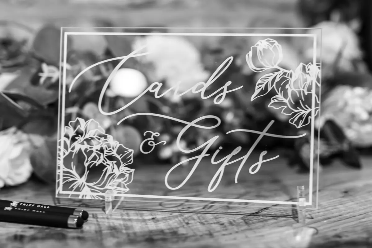 Clear acrylic Cards and Gifts box surrounded by pale flowers