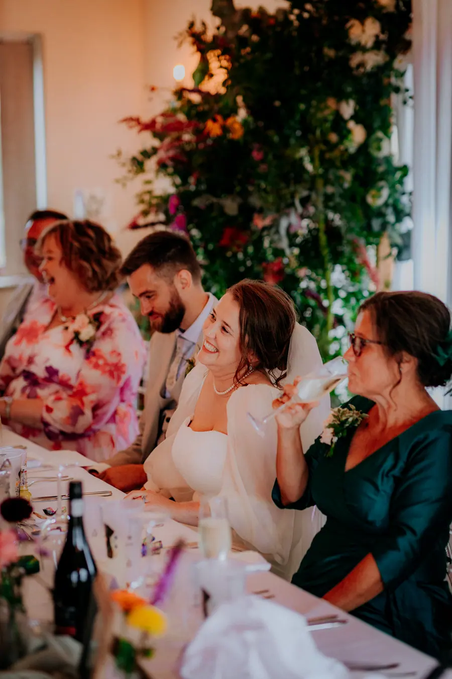 Rae seated at dinner beside Ben and two guests at the top table