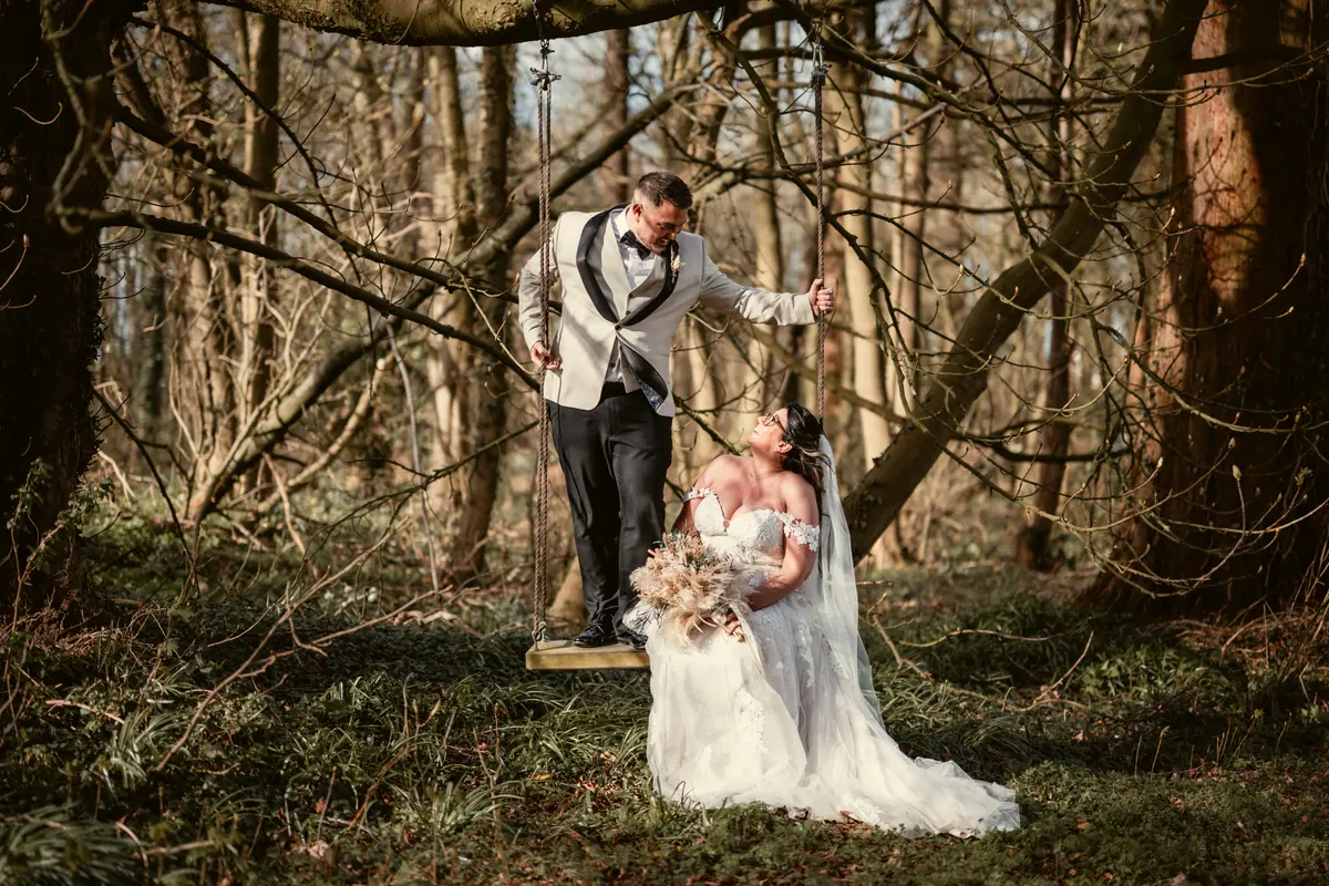 Dan standing behind Star among bare branches in the wooded grounds