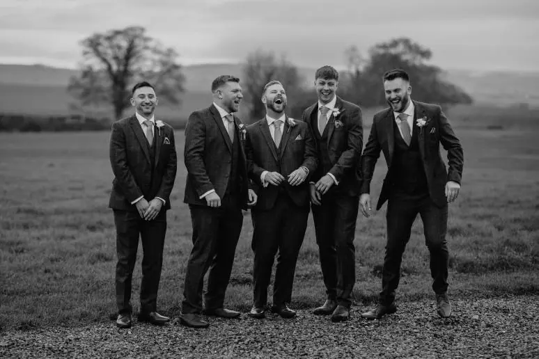 Scott with four groomsmen lined up against the open fields