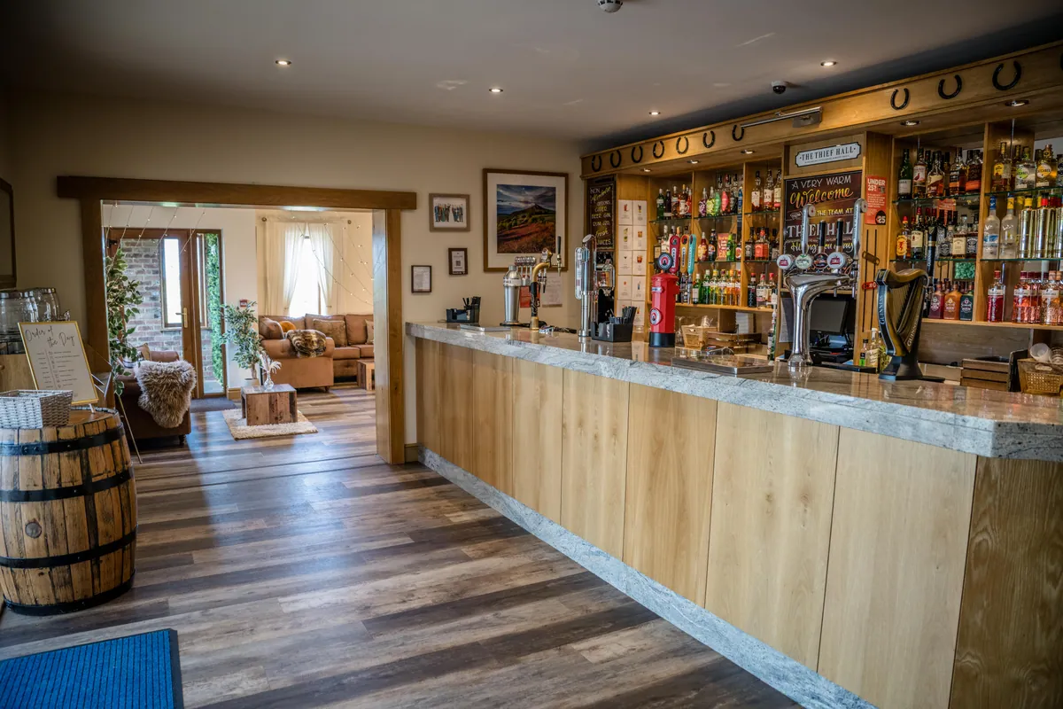 The stocked bar opening into the lounge