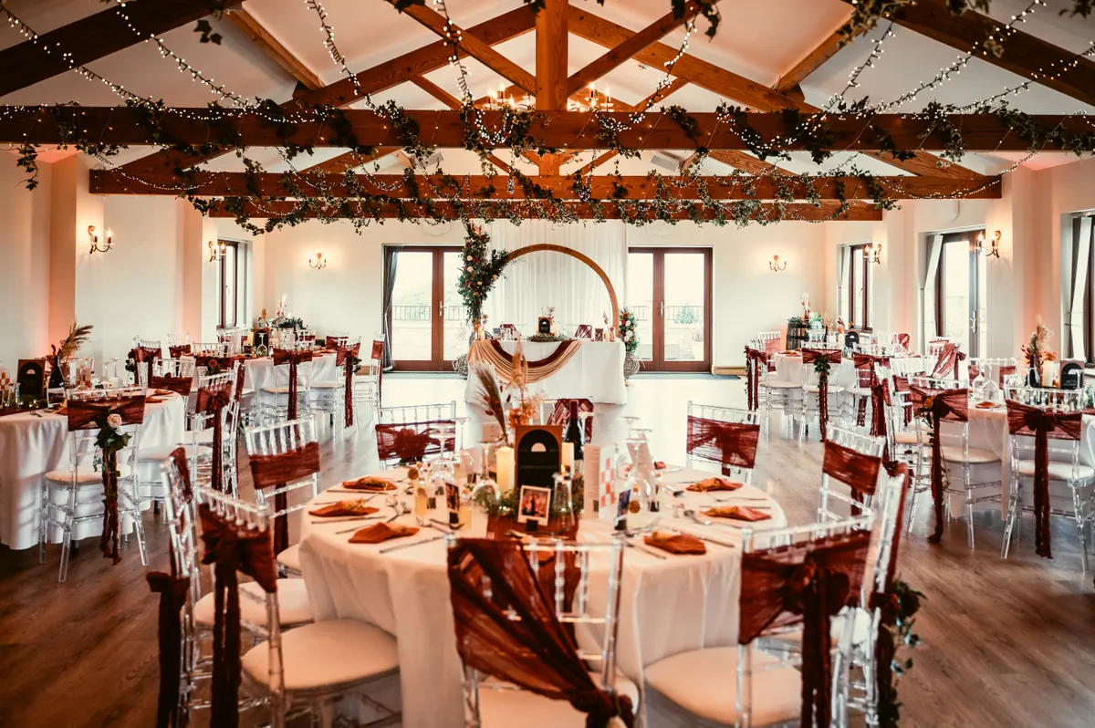The Big Hall dressed for a wedding breakfast with flowers and hanging greenery
