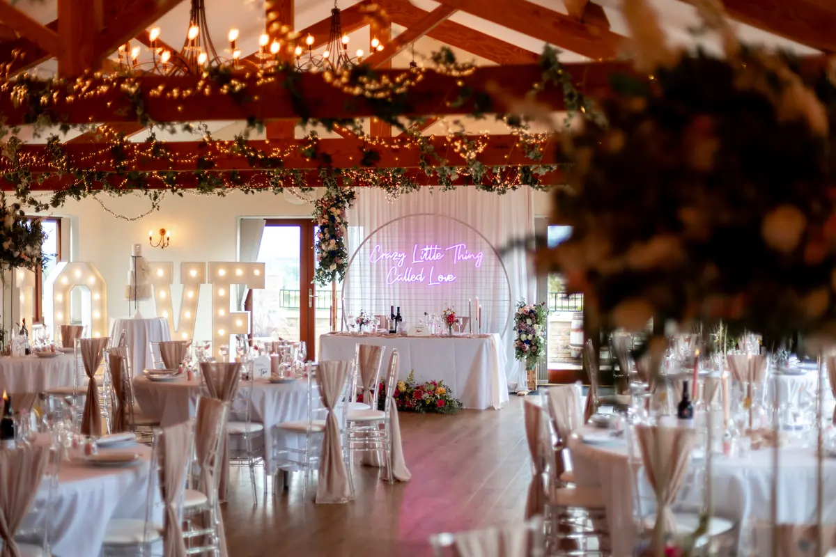 Wedding reception tables under the Hall’s beams and fairy lights