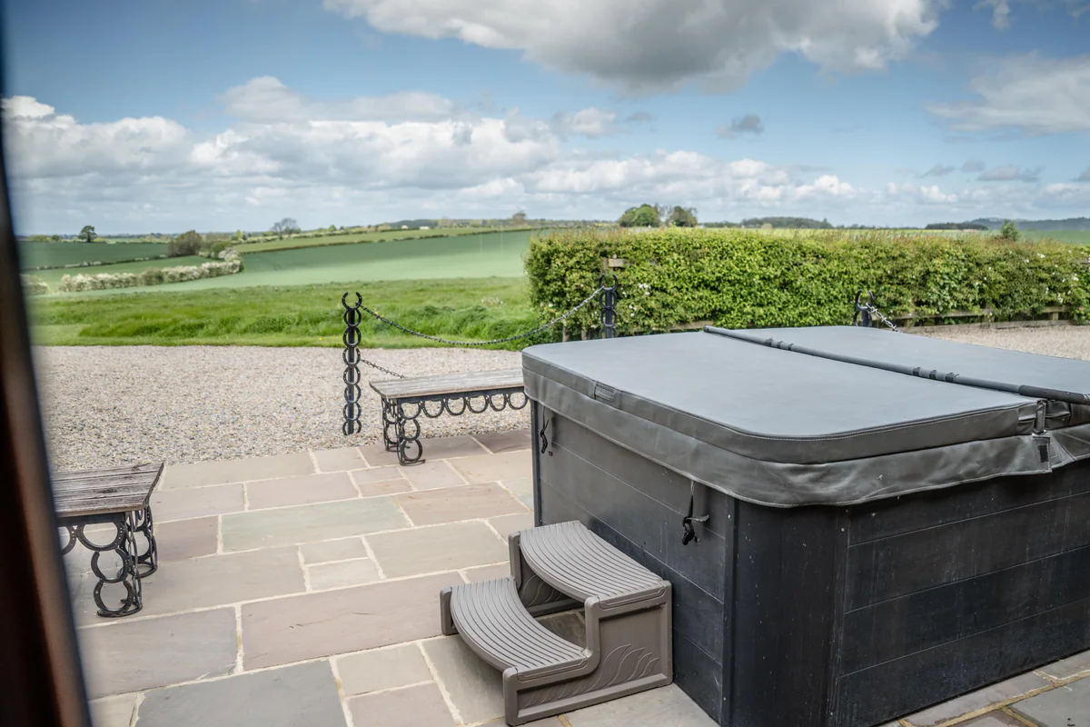 A private hot tub terrace beside the Thief Hall cottages