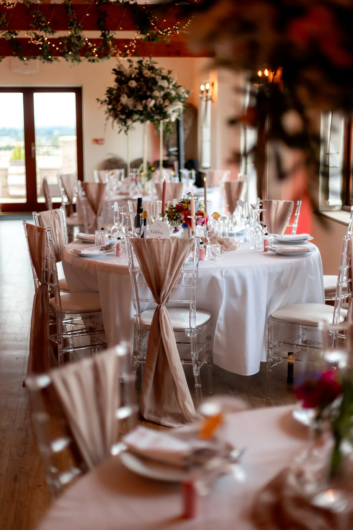 Wedding tables dressed with flowers, glassware and candles