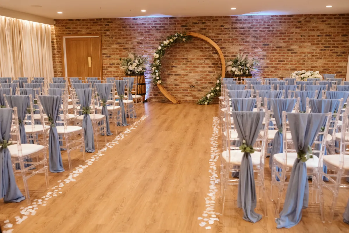 The Hall arranged for a wedding ceremony with an aisle leading to a floral circle