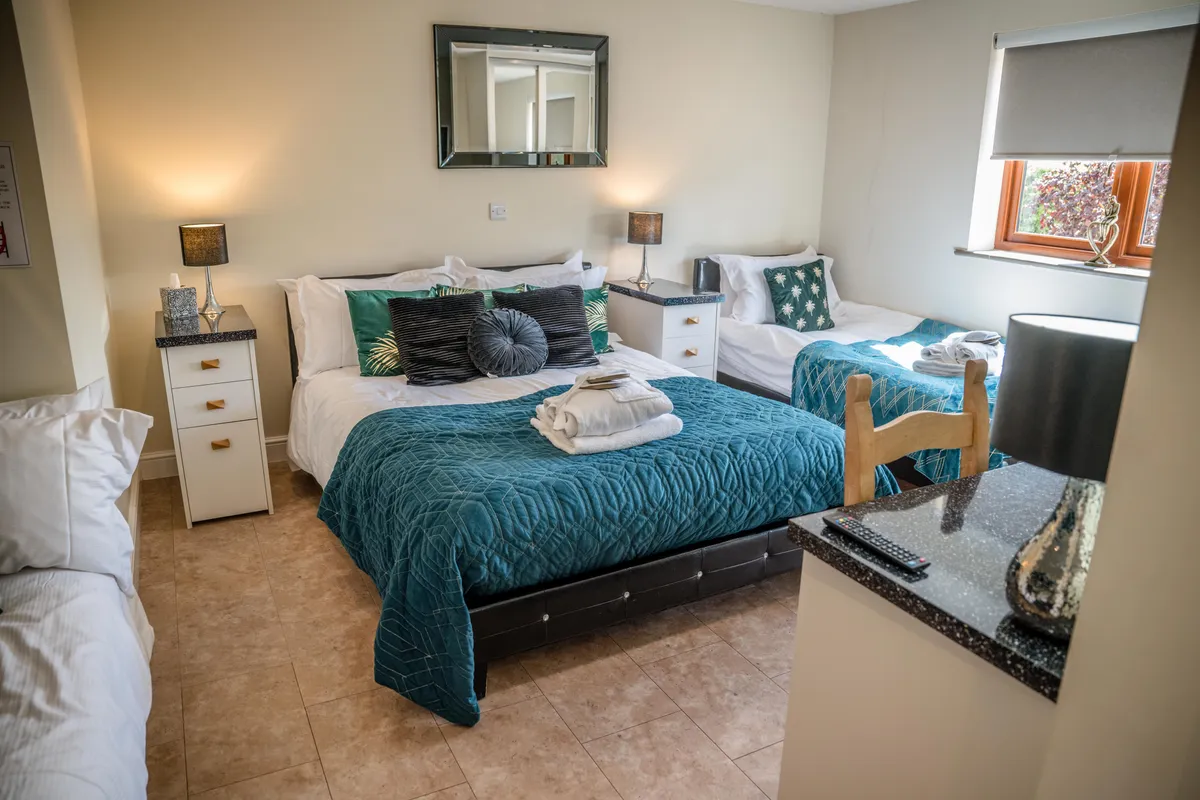 Bedroom with teal bedding in Millington House