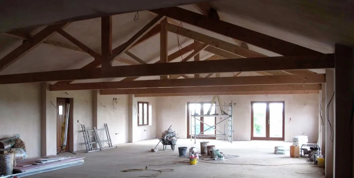 The Hall interior during construction, with timber beams and unfinished walls