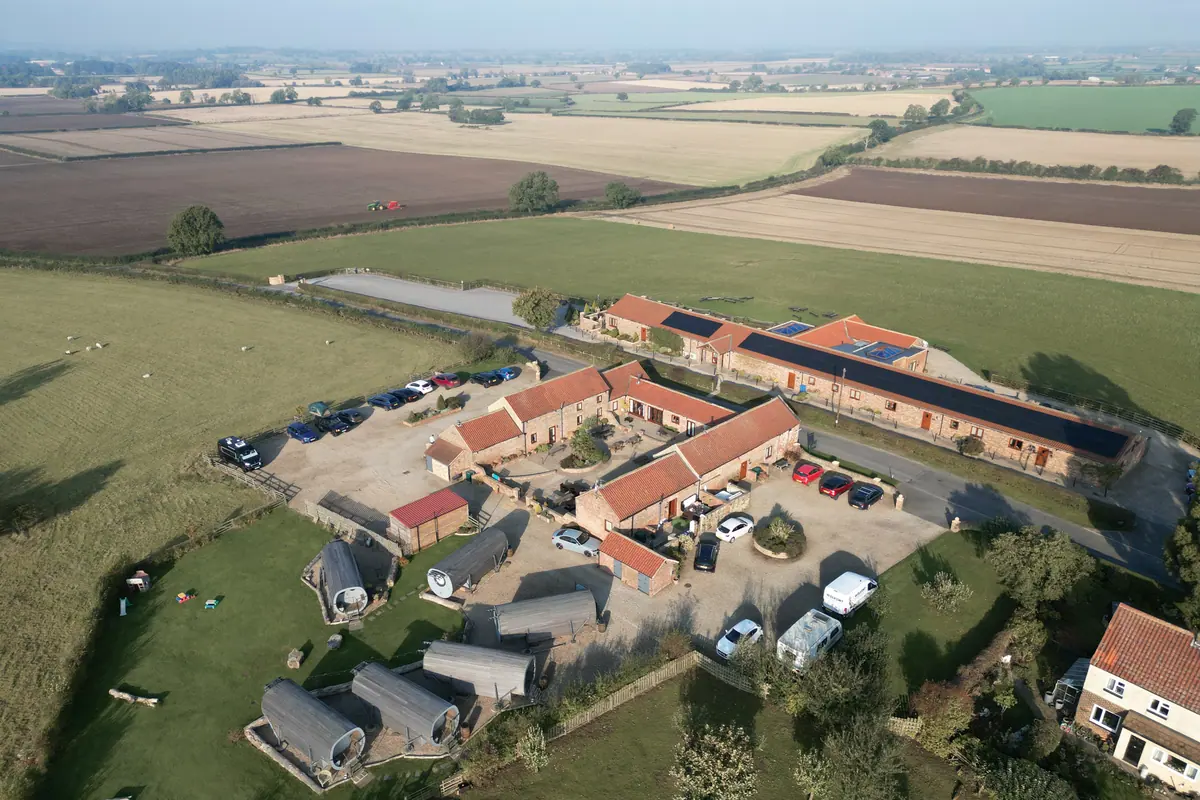Thief Hall's brick barn ranges, courtyard and accommodation across the estate